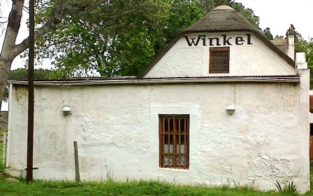 The old village shop at Mamre &mdash; a low whitewashed building with a thatched gable lettered "Winkel".