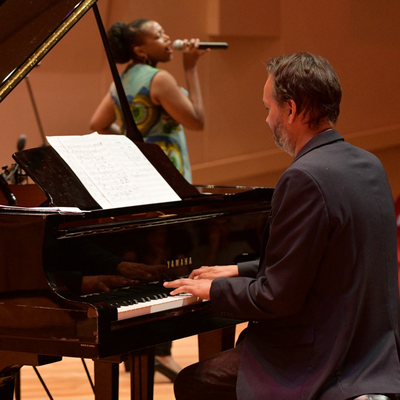 Ramon Alexander accompanying a vocalist at the piano during a concert at the Endler Hall, Stellenbosch.